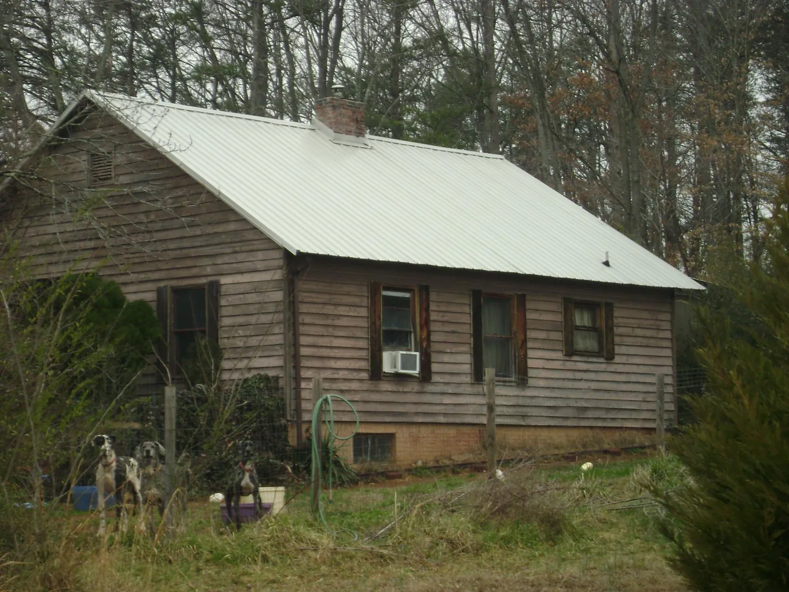 White metal roof on an old wood sided farmhouse, from a Metal Roof Installation job in Mohrsville